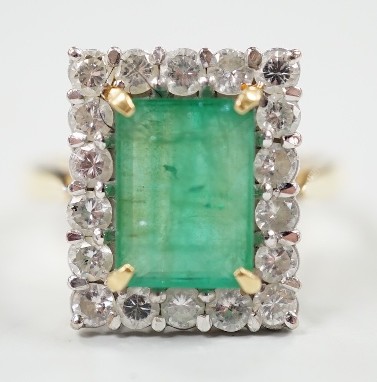 A modern 18ct gold, emerald and diamond set rectangular cluster ring, size Q, gross weight 6.4 grams.